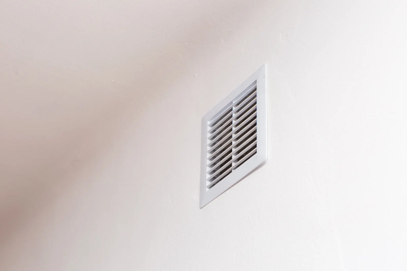 Floor register vent in a home with warm wood flooring
